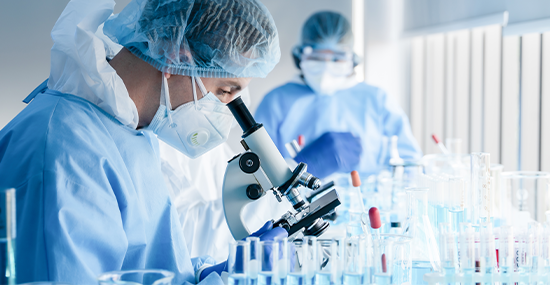 Doctor in UHS checking a microscope to examine a sample