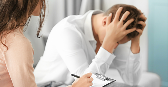 A Psychiatrist counselling a patient